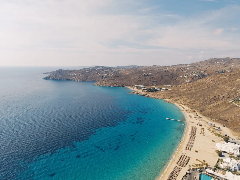 Turquoise bay and sandy beach on Mykonos seen from above